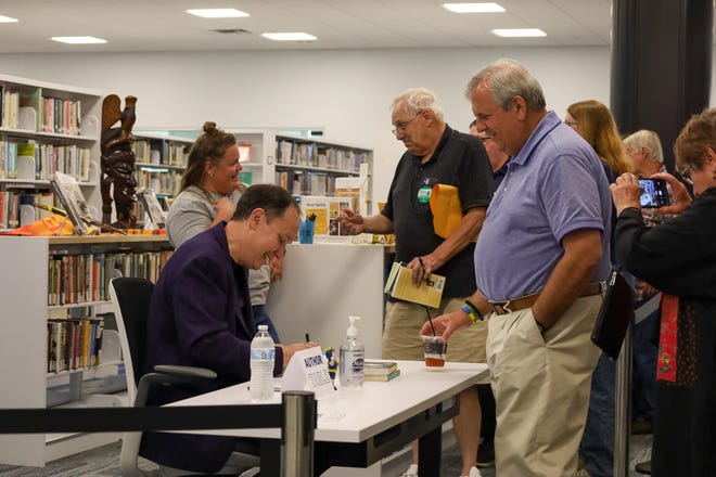 Audience members lined up after the presentation to have their editions of Jamie Ford's novels signed by the author, getting a chance to chat individually with the writer.