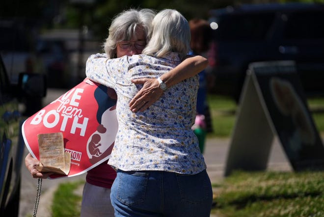Mari Schoen from Gahanna hugs a fellow supporter as they celebrate the overturning of Roe v. Wade by the Supreme Court while standing outside of the Planned Parenthood Clinic on East Main Street in Columbus.