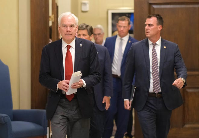 An Oklahoma-based journalist has sued Attorney General John O'Connor, at left, and Gov. Kevin Stitt over delays to an open records request.