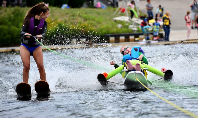 Vicky Kalinowski, right, of Webster, is pulled by a ski boat for the first time as Holland Aqua Riders' Samantha Naples of Holland keeps an eye on her during Friday's Adaptive Skiing at the Webster Water Ski Collective on Lake Quinsigamond in Shrewsbury.