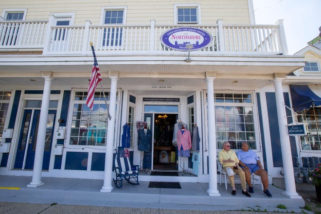 (right) Brian L. George, owner of Northshore Sea Bright, a store which has offered shore-inspired clothing and classic styles since 1982, talks to his friend and customer, (left) Bob Moore of Long Branch, outside of his business in Sea Bright, NJ Friday, June 24, 2022. 