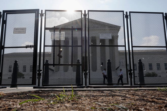 The U.S. Supreme Court Building is seen through a temporary security fence on June 23, 2022 in Washington, DC. Decisions are expected in nine more cases before the end of the Court's current session, with some activists waiting on a highly-anticipated ruling on the potential overturning of Roe vs Wade.