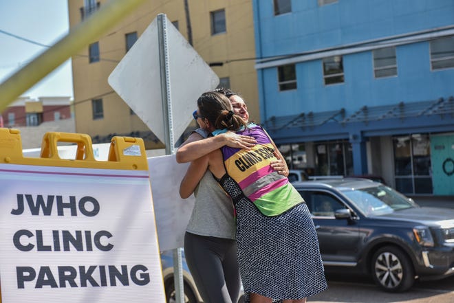 A clinic escort hugs a crying woman outside of the Jackson Women's Health Organization after the U.S. Supreme Court overturned Roe v. Wade in Jackson, Miss., Friday, June 24, 2022.