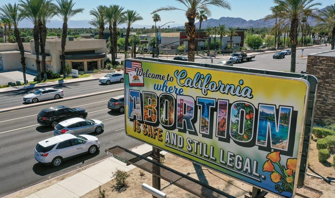 A billboard reading "Welcome to California where abortion is safe and still legal" stands near the intersection of Highway 111 and Bob Hope Dr. in Rancho Mirage, Calif., June 24, 2022.