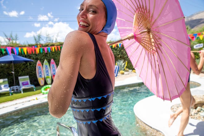 Tyler Rolling of Aqualillies performs at the pop-up "HI-CHEW Fantasy House" in Palm Springs, Calif., on June 23, 2022. The performance included flips and other synchronized acrobatic movements performed in the pool.