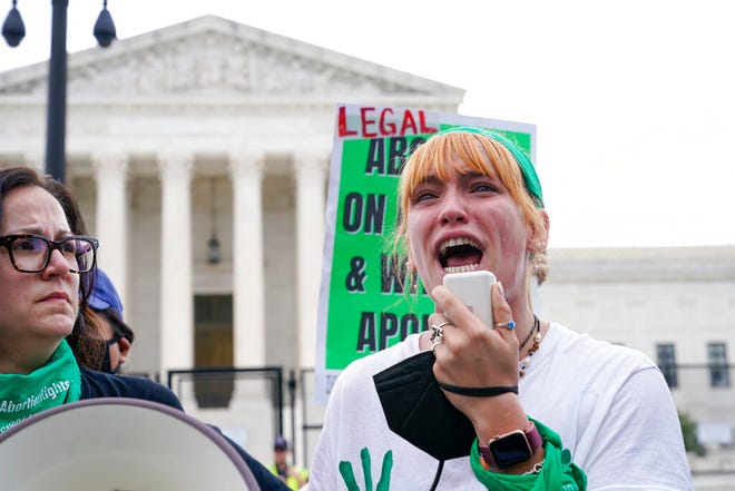 A tear rolls down an abortion-rights activist's cheek as they speak outside the Supreme Court in Washington, Friday, June 24, 2022.Â TheÂ Supreme CourtÂ has ended constitutional protections for abortion that had been in place nearly 50 years in a decision by its conservative majority to overturnÂ Roe v. Wade.Â (AP Photo/Jacquelyn Martin)