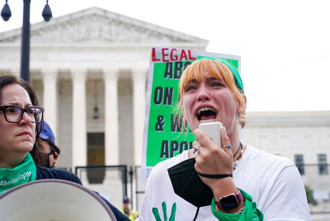 A tear rolls down an abortion-rights activist's cheek as they speak outside the Supreme Court in Washington, Friday, June 24, 2022. The Supreme Court has ended constitutional protections for abortion that had been in place nearly 50 years in a decision by its conservative majority to overturn Roe v. Wade. (AP Photo/Jacquelyn Martin)