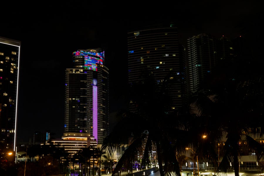 In observance of the one-year anniversary of the deadly Surfside Condominium Collapse, the 60-story Paramount Miami Worldcenter skyscraper lights-up the South Florida skyline with a massive digital memorial message to the families of the victims of the June 24, 2021 catastrophe.