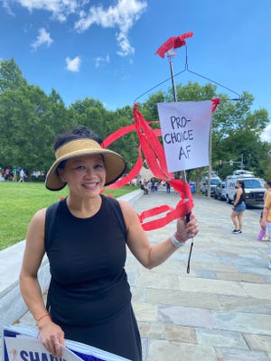 “It’s important to make a statement, that this is what we’re going to go back to— potentially,” said Sophia Lee, clutching a wire coat hanger with red streamers dangling from it to depict pre-Roe America, at the Philadelphia rally.