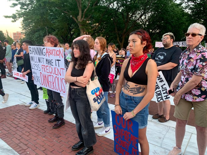 Protesters gather on the State House steps at the start of Friday's demonstration.