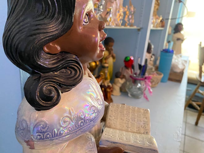Angel figurines and statues adorn the shelves and walls of Peggy's Heavenly Home Cooking on S. Cleveland St.