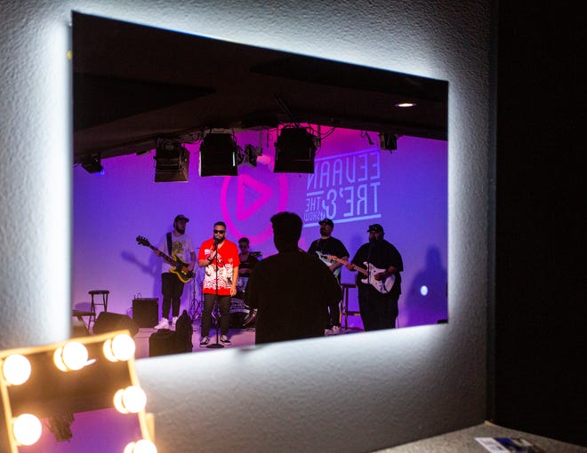 Eevaan Tré and The Show are seen in a mirror playing for a sound check before a Spotlight Sessions performance at LevelOne11 in Palm Desert, Calif., Thursday, June 16, 2022.
