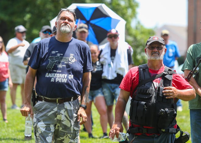 Don Quill of Newark (left) and Robert Ashby of New Castle are armed as they attend a pro-gun rights rally on the Legislative Mall in Dover, Saturday, June 25, 2022.