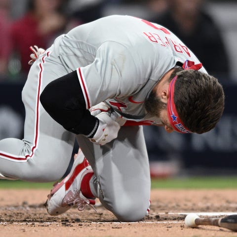 Bryce Harper falls to the ground after being hit b