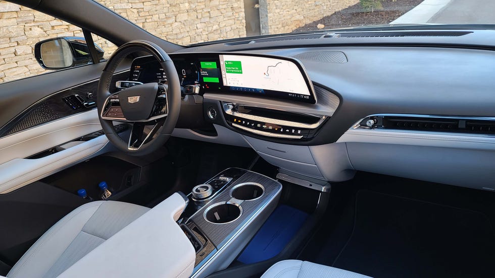 The interior of the 2023 Cadillac Lyriq EV sits under a single-pane, panoramic glass roof with 33-inch screen and floating console wrapped in leather. Oddly, the dash is not cut-and-sewn leather but is a soft vinyl material.