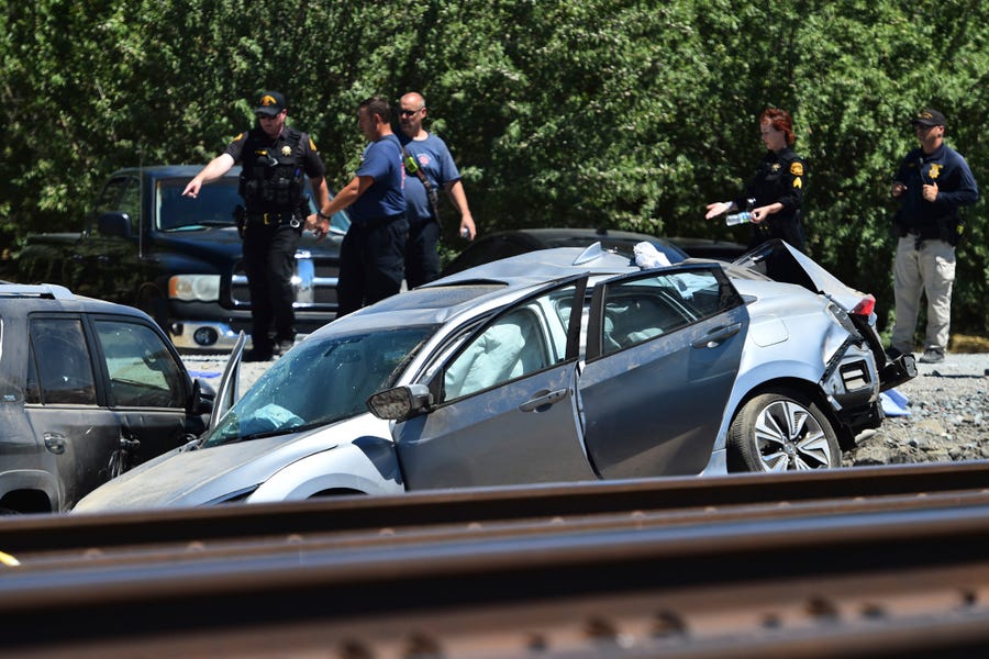 Contra Costa Sheriff deputies investigate the scene after an Amtrak train collided with a vehicle in Brentwood, Calif., on Sunday, June 26, 2022.