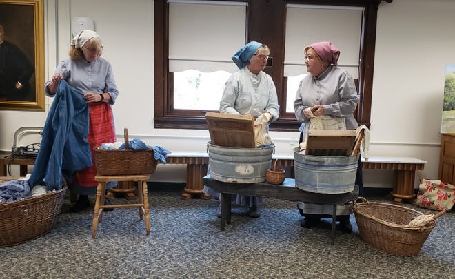 The "Dairy Maids of Bishop Hill" performed "Dirty Laundry" for the Henry County Genealogical Society Monday at the Kewanee Public Library. Shown, from left, are maids Vicki Massie, Jean Combite and Dianne Lindbom. The group has performed the skit, written by Cheryl Dawell, since 2019.  They will perform at the Geneseo Public  Library Wednesday June 29 at 2 PM