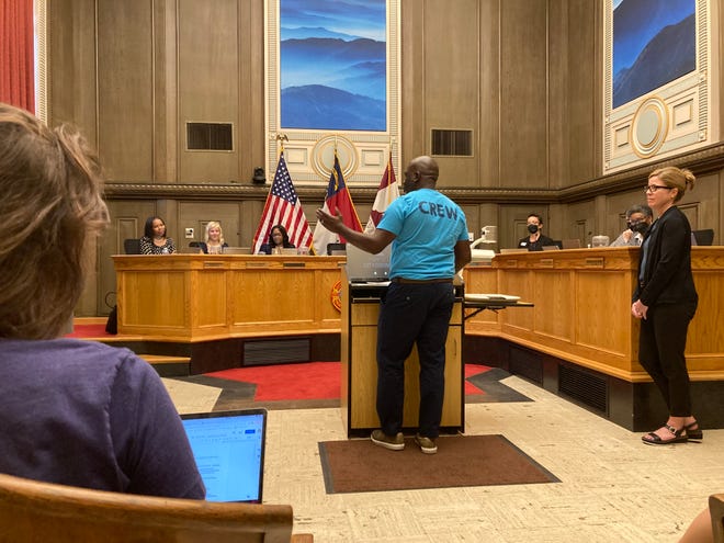 Asheville City Council returns to the Council Chamber in city hall for its meeting on June 28, 2022. Parks and Recreation Director D. Tyrell McGirt accepts a proclamation from council