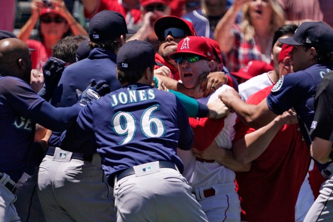 Several members of the Seattle Mariners and the Los Angeles Angels scuffle after Mariners' Jesse Winker was hit by a pitch during the second inning of a baseball game Sunday, June 26, 2022, in Anaheim, Calif. (AP Photo/Mark J. Terrill)