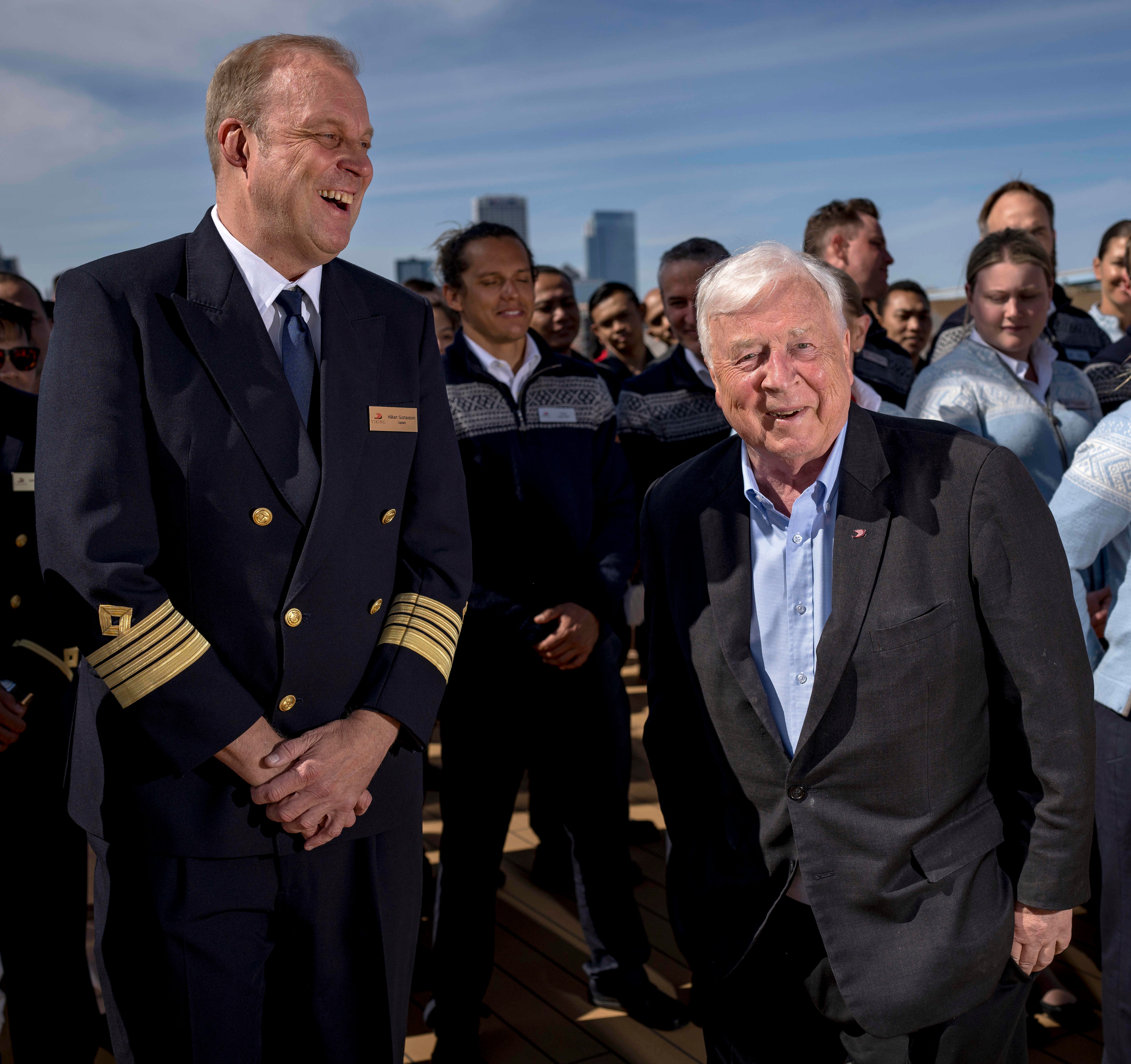 Captain Hakan Gustavsson, left, laughs with CEO of Viking Cruises Torstein Hagen before a group photo aboard the Viking Octantis as it leaves Milwaukee to traverse Lake Michigan.