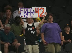 A Phoenix Mercury fan holds a sign in support of center Brittney Griner during the third quarter against the Indiana Fever at Footprint Center. Griner has been detained in Russia on a drug charge since February.