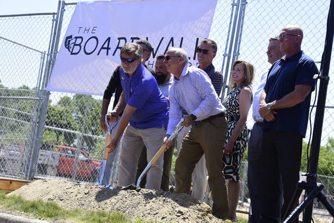 Frank Moore (middle-right), is accompanied by the executive director and founder of the Riverbank organization Kathy Vertin (back) and St. Clair County Chairman Jeff Bohm (right) during the groundbreaking ceremony for the new Boardwalk Theatre in downtown St. Clair on Tuesday, June 28, 2022.