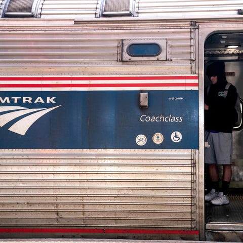 A traveler boards an Amtrak train in Wilmington, D