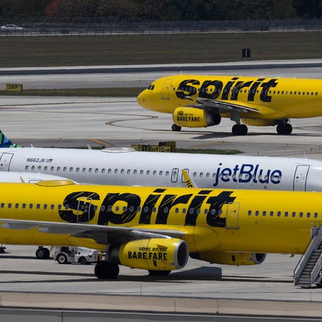 A JetBlue Airlines plane is seen near Spirit Airlines planes at the Fort Lauderdale-Hollywood International Airport on May 16, 2022 in Fort Lauderdale, Florida.