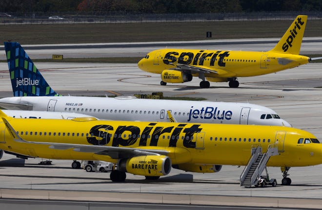 A JetBlue Airlines plane is seen near Spirit Airlines planes at the Fort Lauderdale-Hollywood International Airport on May 16, 2022, in Fort Lauderdale, Florida.