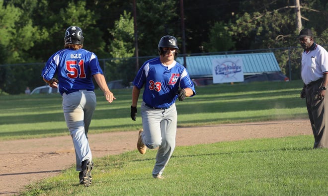 Cambridge Post 84's Andy Ogle (51) comes on to run for teammate Hayden Loy (33) who had just ripped a double for Post 84 during Tuesday's American Legion game with St. Clairsville Post 129 at Don Coss Stadium.
