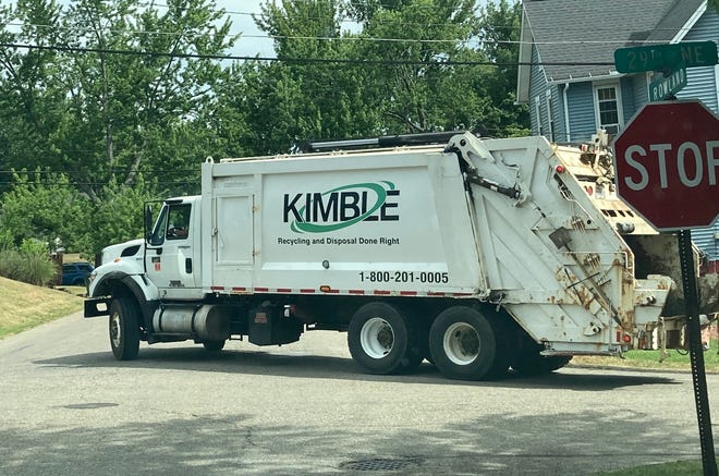 A Kimble Recycling & Disposable Inc. collection truck removes rubbish Wednesday along Rowland Avenue NE at 29th Street NE in Canton.