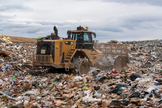A landfill compactor works on a section at the Larimer County landfill in Fort Collins on Wednesday, June 29, 2022.