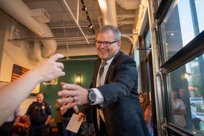 Larimer County sheriff candidate John Feyen prepares to make a toast during his primary election party at Colorado Coffee Company at the Foundry in Loveland on Tuesday.