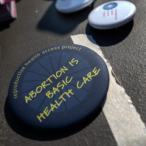 Buttons give a message about abortion as health ca