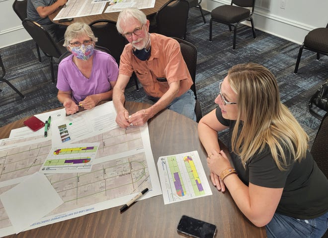 Stacy Bellis, executive director of the Marine City Area Chamber of Commerce, right, talks with other residents at her table during an input session on the Marine City Highway corridor plan on Wednesday, June 29, 2022.