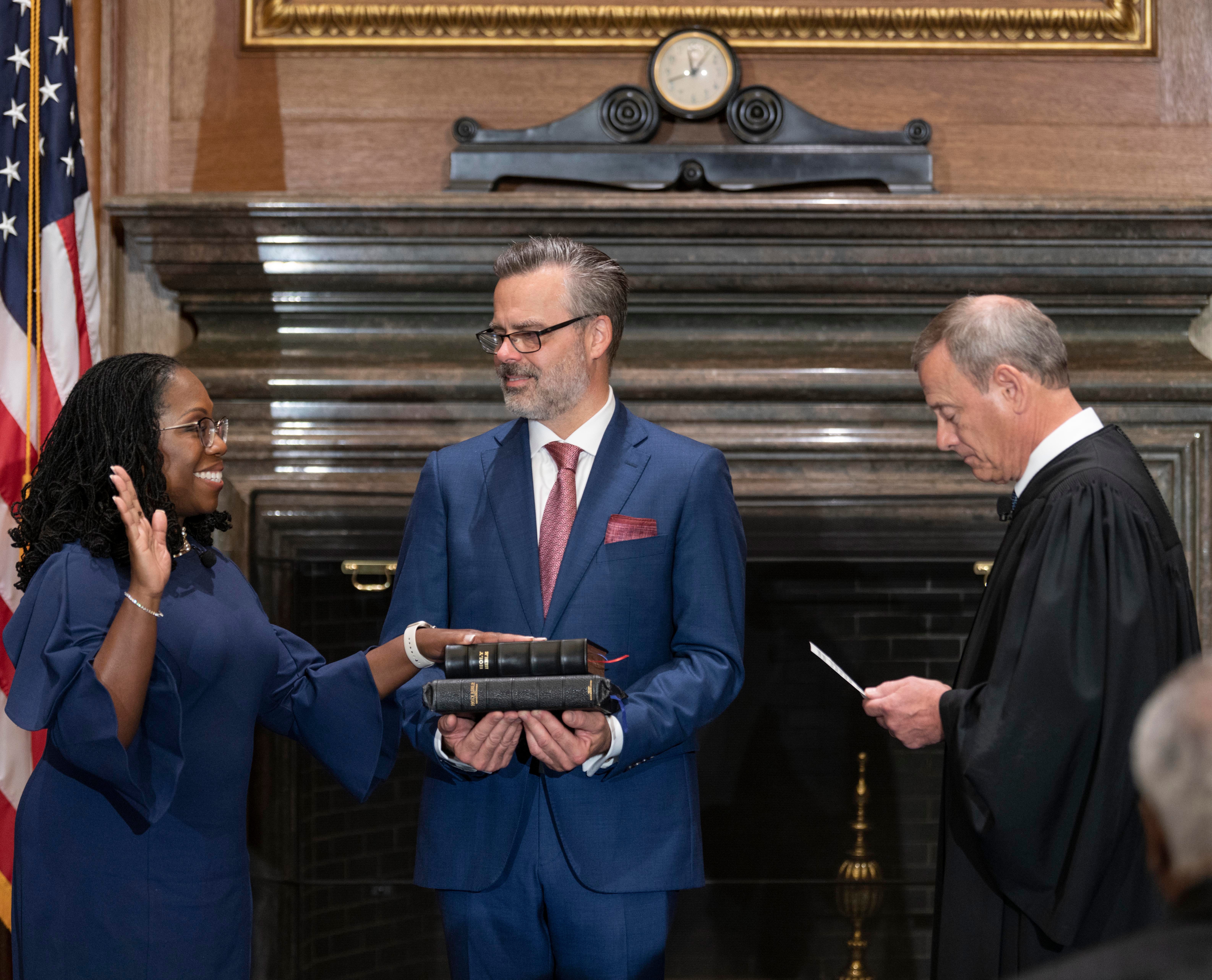 Chief Justice John Roberts swears in Justice Ketanji Brown Jackson, accompanied by her husband, Dr. Patrick Jackson.
