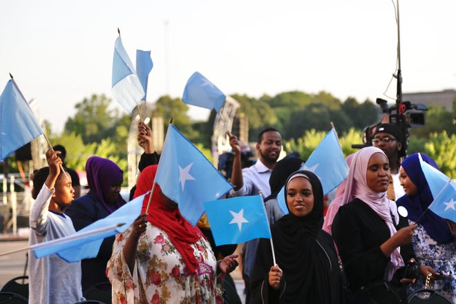 A crowd waves Somali flags at the Somali Independence Day celebration at Columbus City Hall Thursday.