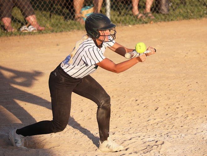 Kylee Logan attempts a bunt in West Burlington-Notre Dame softball game against Louisa-Muscatine.