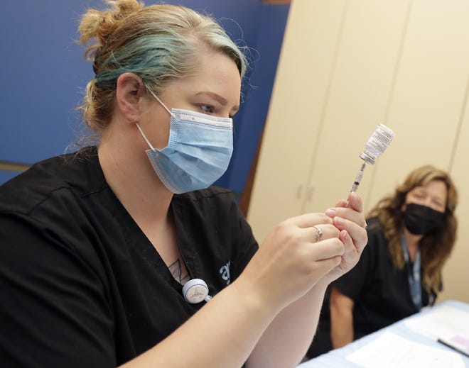 AMI's Desiree Wilhelm prepares a vaccination during the Multicultural Coalition, Inc. (MCI) vaccination clinic including children 6 months and up on Tuesday, June 28, 2022 at the Neenah Public Library in Neenah, Wis. 
Wm. Glasheen USA TODAY NETWORK-Wisconsin