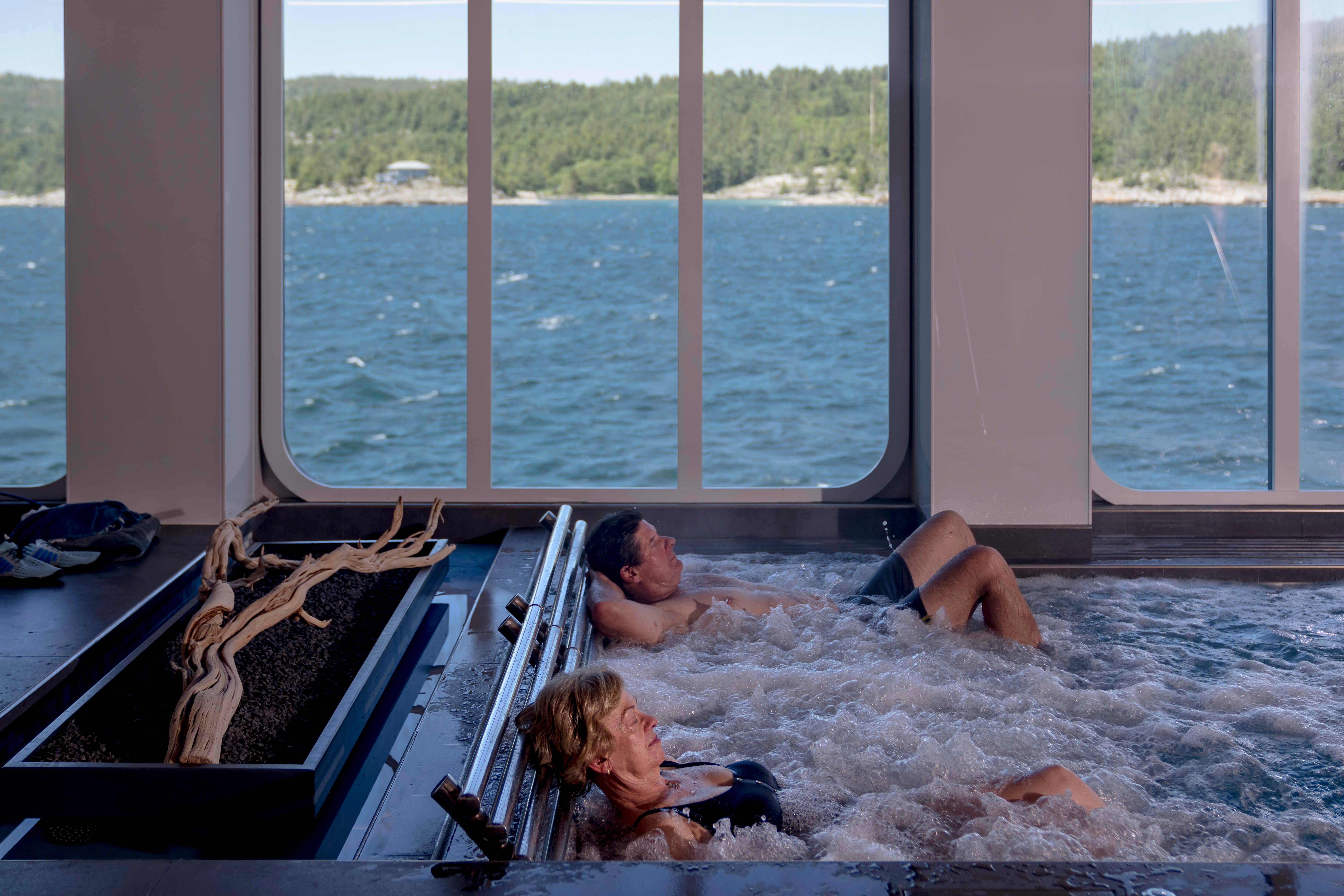 Pat Jones of Johnson City, Tennessee, front, and Robin Daniel of DeQueen, Arkansas, relax in the Nordic Spa Pool on Viking Octantis in Frazer Bay in Ontario, Canada, on June 22.