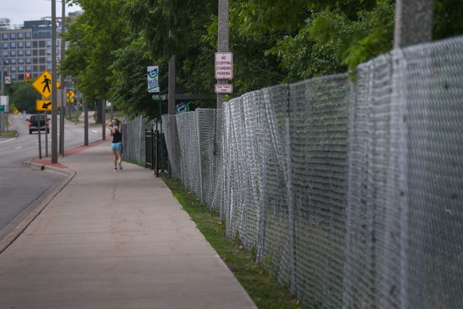 Fencing seen along Michigan Avenue near Beal Street in East Lansing, seen Friday, July 1, 2022.