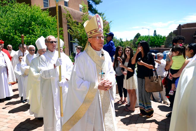 New Archbishop of Santa Fe, N.M., John C. Wester enters the Cathedral Basilica of St. Francis of Assisi for the Mass of Installation, on June 4, 2015, in Santa Fe, N.M. Archbishop Wester is speaking about the decision to mortgage the iconic Santa Fe cathedral to meet a settlement agreement tied to church sex abuse victims. The archbishop sent letters to parishes last month informing them they would collectively need to borrow $12 million to pay for the settlements.