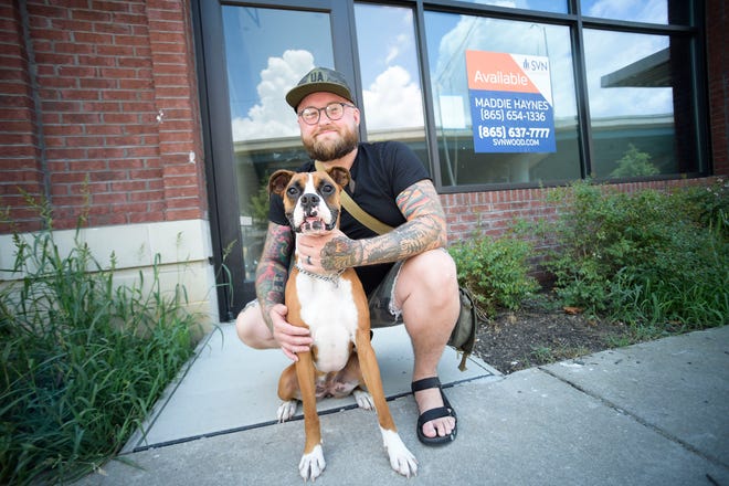 Nick Kitsos and his 3-year-old boxer Charlie get ready to open Loyal;s Barbershop at 204 W. Magnolia Ave. in Knoxville. Kitsos is moving his barbershop from Columbus, Ohio, to Knoxville and aims to open mid-July.