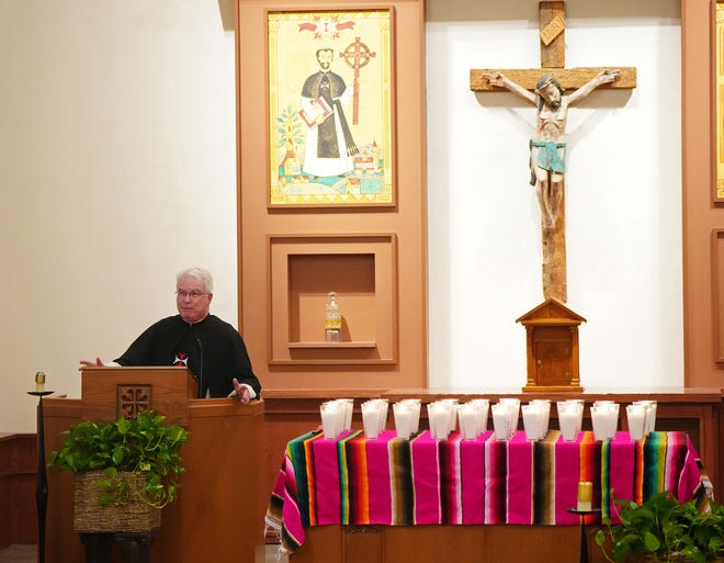 Father Jude Verley speaks to Promise Arizona (PAZ) members as they honor the lives of 53 migrants who died crossing the border in a tractor-trailer during a vigil at Crosier Village.