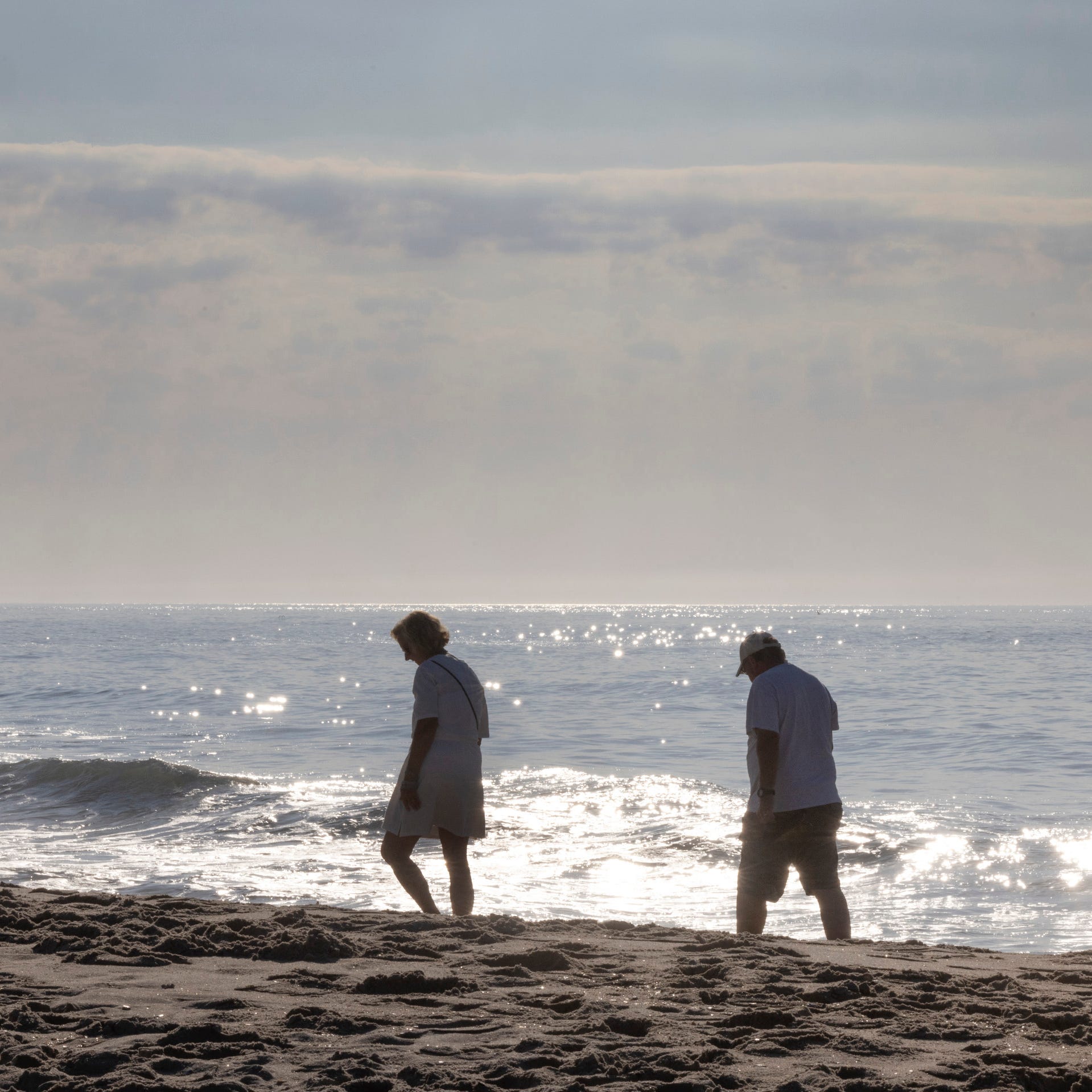 A couple walks the beach on Long Beach Island.
