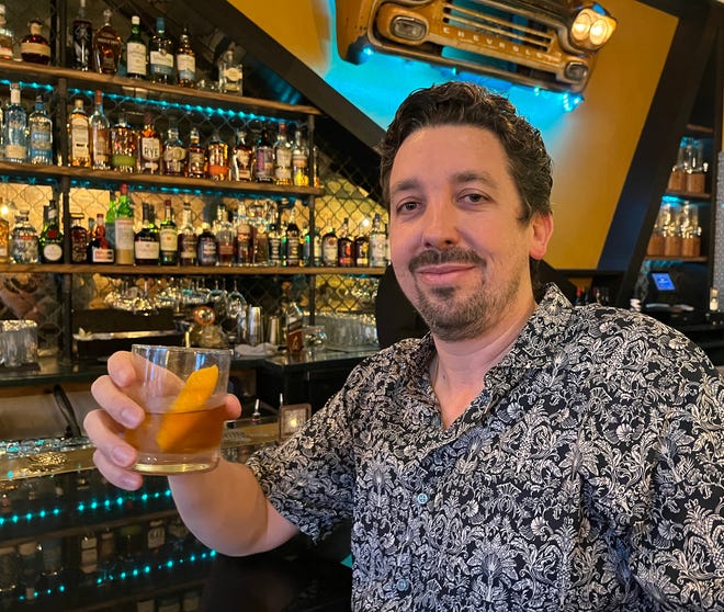 Allan Soto enjoys an "Anibal old-fashioned," a cocktail named after his grandfather, at the bar of his eatery Pineapple Ink Tavern in Augusta, Georgia, which was re-opened July 6, 2022, as a Cuban restaurant.