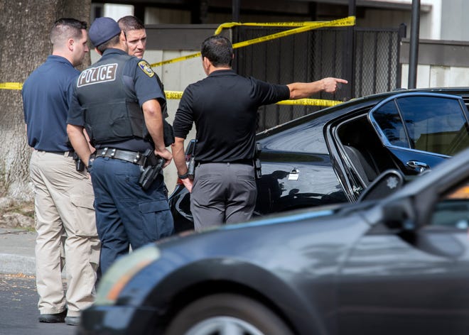 Stockton police detectives check out a Honda Accord that crashed after a shooting killed one man and injured another in north Stockton on Tuesday, July 5, 2022.