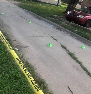 Cones of the type police use to mark evidence could be seen Tuesday morning at a homicide scene near 233 S.E. Lawrence. A preliminary hearing began Monday for a man accused of being responsible.