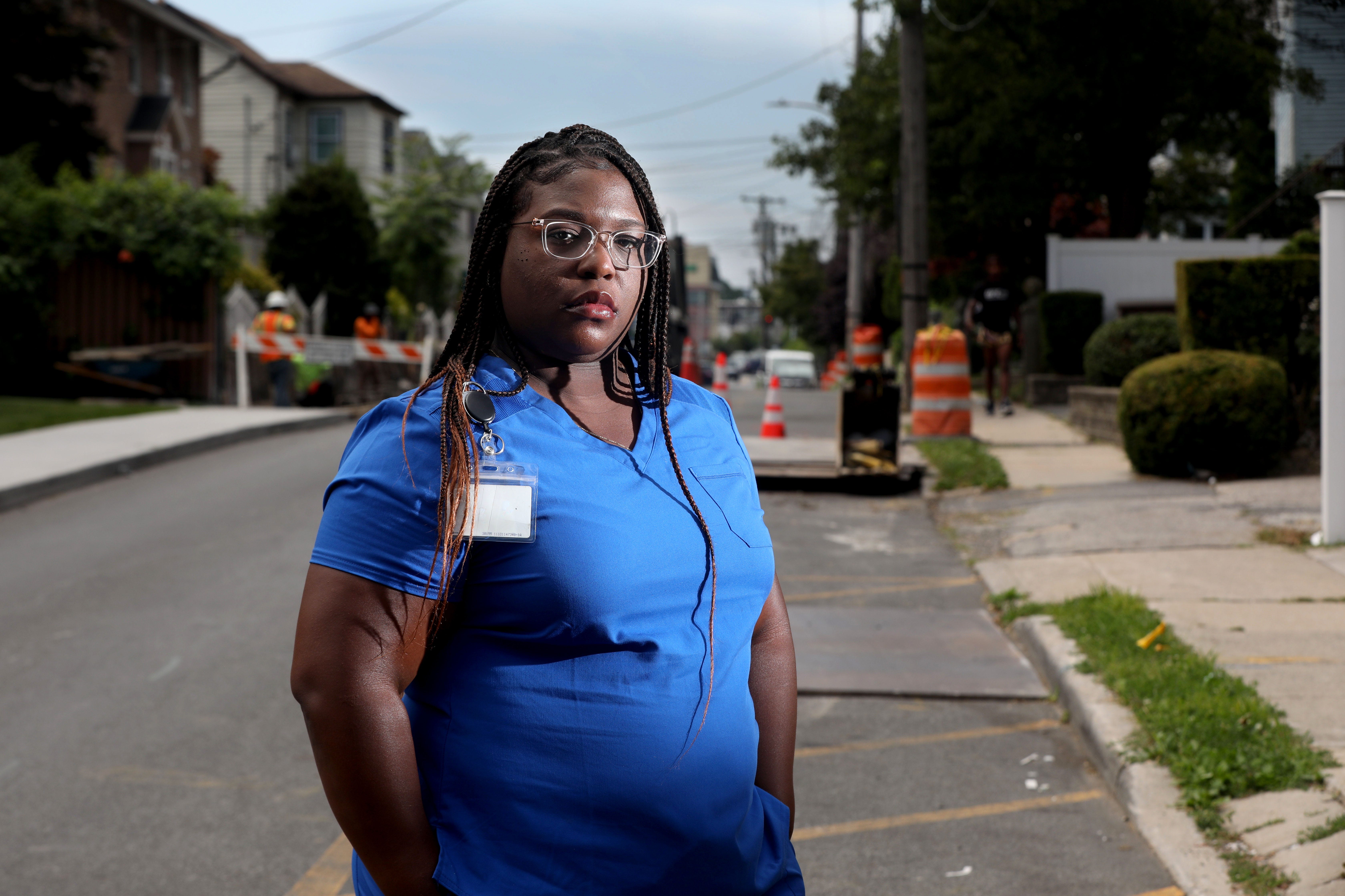 Raisa Brown stands near the home she used to live in Mamaroneck, New York on July 5, 2022. Brown rented the entire first floor of the house, which was flooded during Hurricane Ida in 2021. Brown, who moved in to the home four months before Ida, says that she would not have rented the house had she known that it was in a flood prone area.