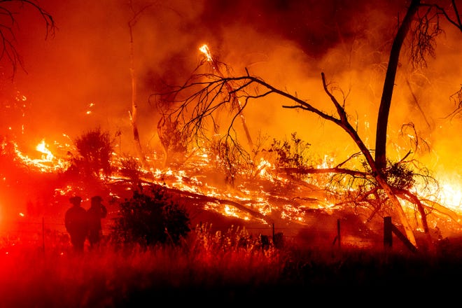 Firefighters battle the Electra Fire in the Rich Gulch community of Calaveras County, CA on Monday, July 4, 2022. According to Amador County Sheriff  Gary Redman, approximately 100 people sheltered at a Pacific Gas & Electric facility before being evacuated in the evening. Photo credit: AP/Noah Burger